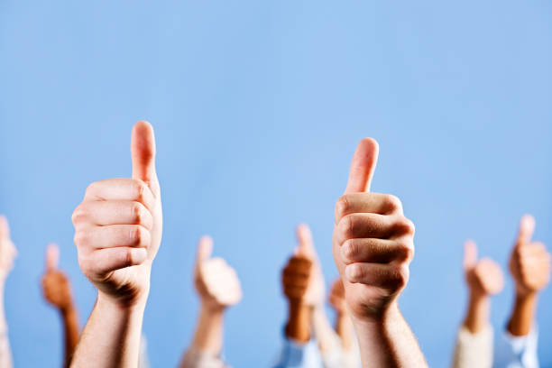 istock Many mixed hands make thumbs up sign against blue 168471510