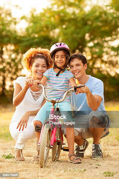 Familia Divirtiéndose En Bicicleta Al Aire Libre Foto de stock y más banco de imágenes de Andar en bicicleta - Andar en bicicleta, Aire libre, Bicicleta