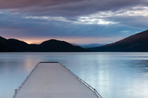 A dock at sunset. Summer scenic. Moody sky. Whitefish, Montana, United States.