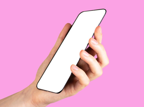 istock Hand holding smartphone mock up, mobile screen mockup on pink background 1684726153