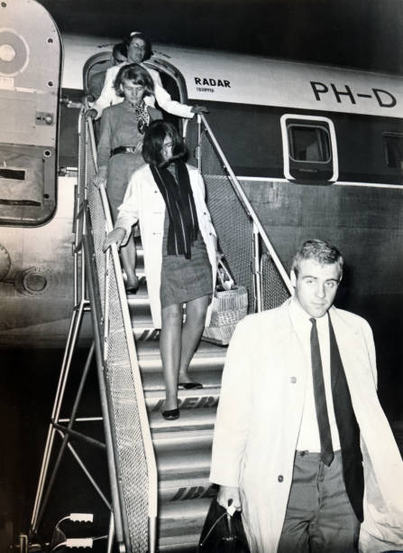 Palma de Mallorca, Spain, 10-05-1968: Vintage roll film, tourists deboarding Transavia flight PH-DSO Douglas DC-7C Seven Seas,  a longer-range variant with non-stop transatlantic capability.