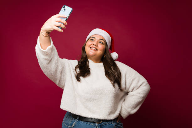 istock Beautiful plus size woman taking a selfie for christmas 1684741993