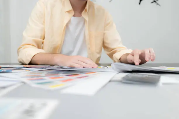 Photo of Young male architect and designer are rethinking the choice of color scheme for designing a smartphone application.