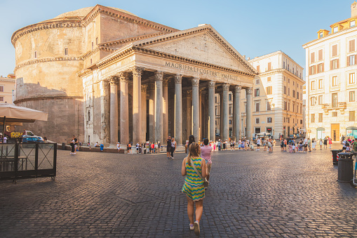 Rome, Italy - August 27, 2023: A young blonde, sightseeing female tourist wanders through the historic Piazza della Rotunda to visit the ancient Roman temple the Pantheon.
