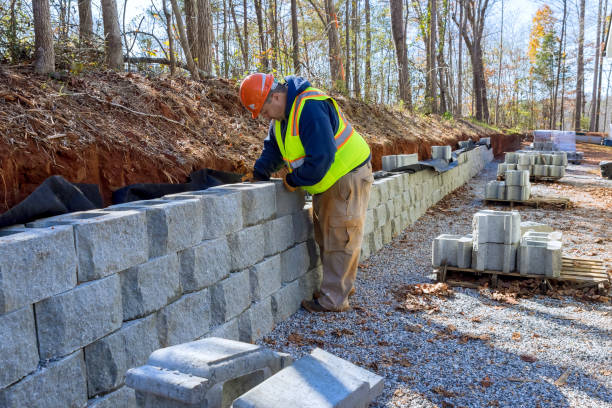 istock Cement blocks are being used by construction worker to build a retaining wall during development of new property. 1684772428