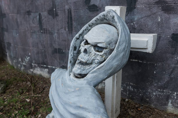 istock Closeup ghost skull with white Celtic cross by dark wall 1684783278