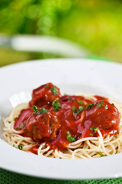 Spaghetti with meatballs Close up spaghetti with meatballs in tomato sauce cooked selective focus vertical pasta stock pictures, royalty-free photos & images