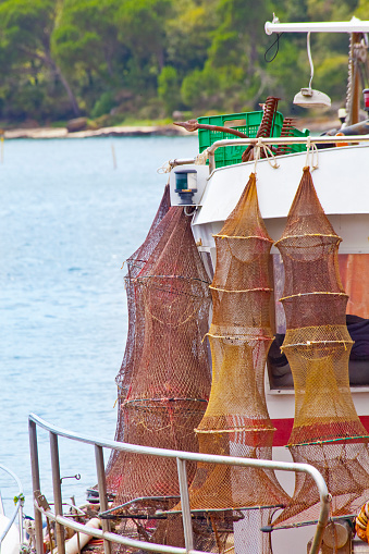 Close-up view of fishing net traps for crabs or lobsters, hanging from fishing boat, drying  in Carril harbor, ría de Arousa, Vilagarcía de Arousa, Pontevedra province, Rías Baixas, Galicia, Spain.