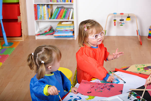 istock Toddlers Offering An Explanation  During Art And Craft  At Nursery 168482337