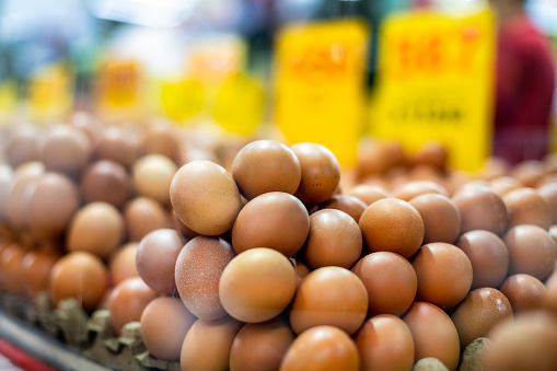Stacked brown eggs in a market