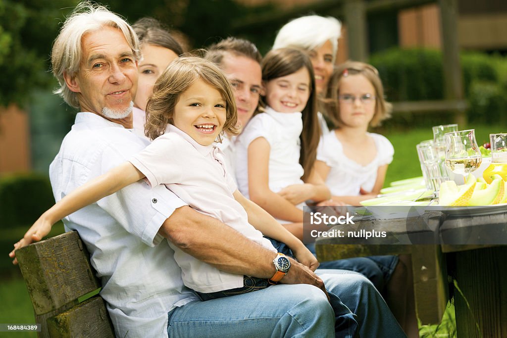 big family having a picnic in the garden a big family are having a picnic in the garden Active Seniors Stock Photo