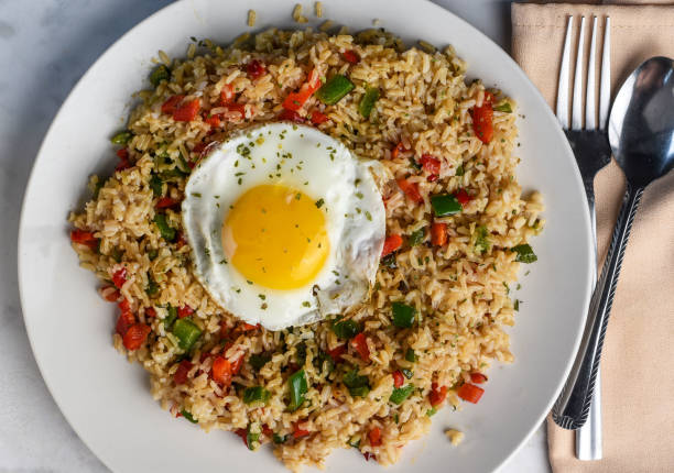 istock brown rice with sauteed peppers and top with fried egg 1684855441