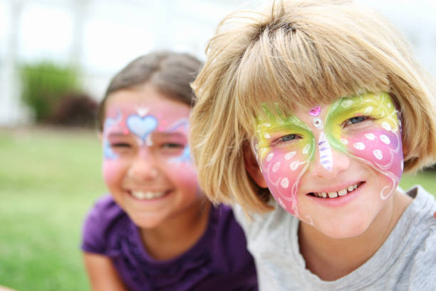 istock Two young smiling girls with their faces painted 168485677