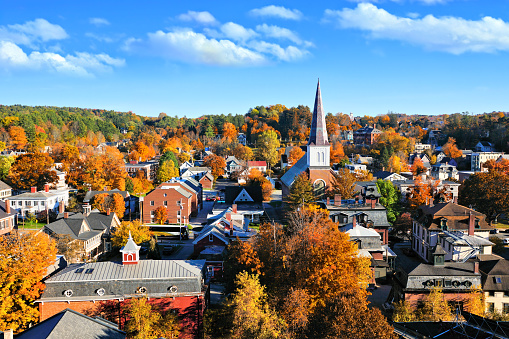Fall view over the historic city of Montpelier, Vermont, USA with church spire and colorful autumn leaves