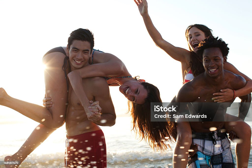 Freunde spielen in den Wellen am Strand - Lizenzfrei 20-24 Jahre Stock-Foto