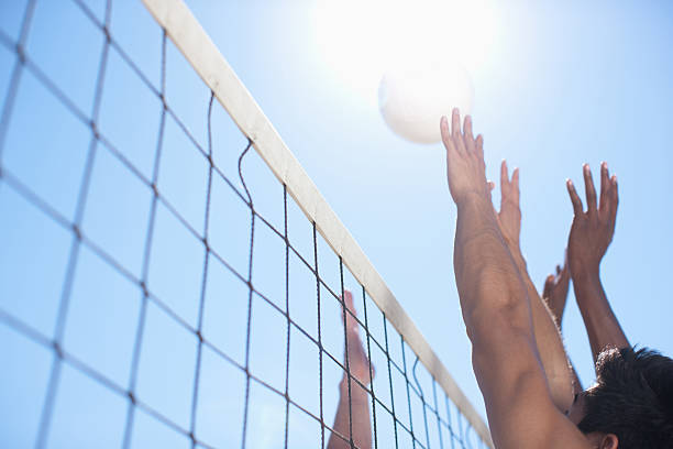 People playing volleyball  volleyball net stock pictures, royalty-free photos & images