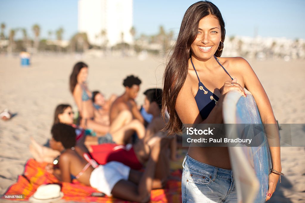 Woman with surfboard on beach  20-24 Years Stock Photo