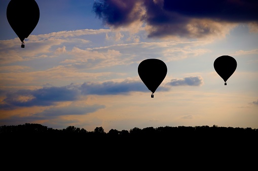 A stunning evening sky with silhouettes of hot air balloons
