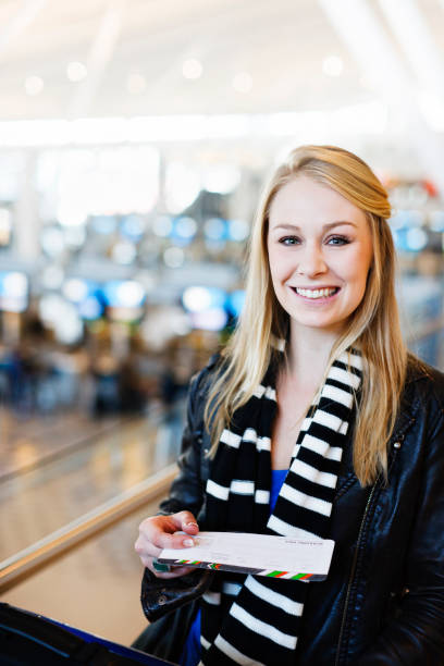 istock blonde with airline boarding pass 168488505