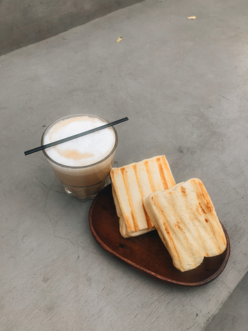 Srikaya toast with flat white coffee on the gray background