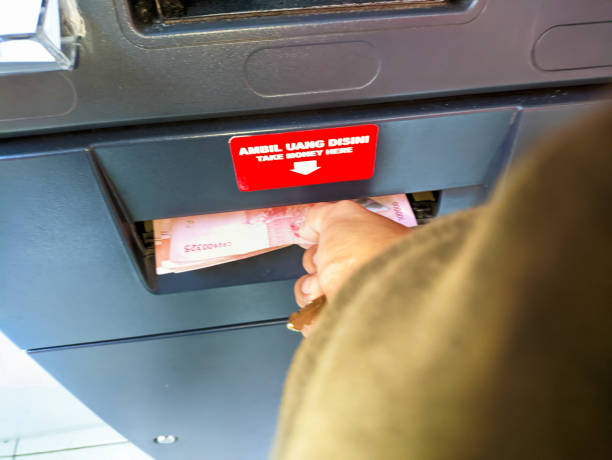 istock a hand takes money from an atm machine 1684888702