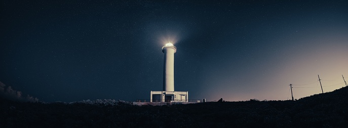 The Cape Zanpa Lighthouse in Okinawa, Japan, with a stunning star field in the night sky behind it