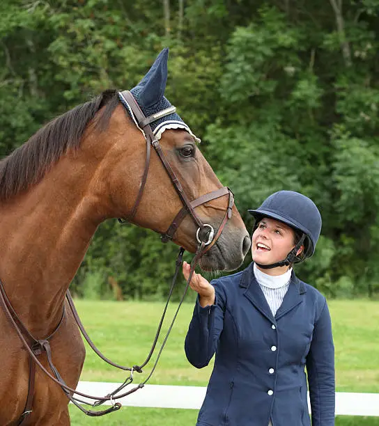 Young rider and her horse at a horse jumping competition, Norway