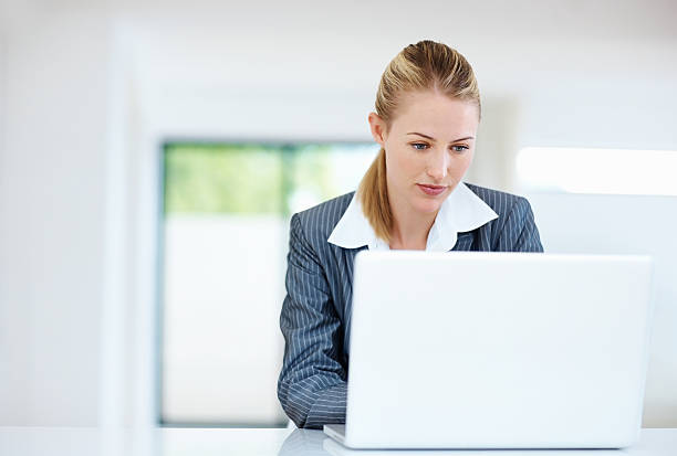 istock Business woman using laptop at work 168490341
