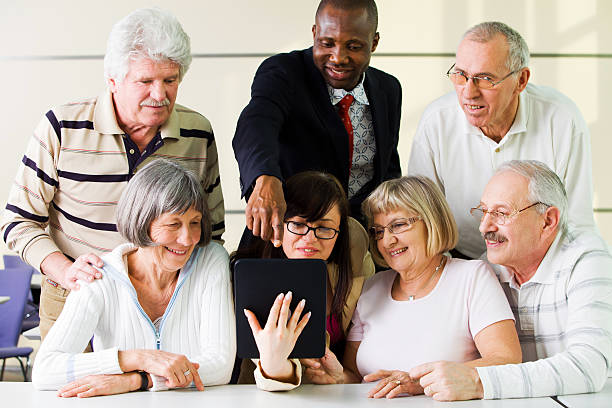 istock Senior students in education room having fun with digital tablet 168490852
