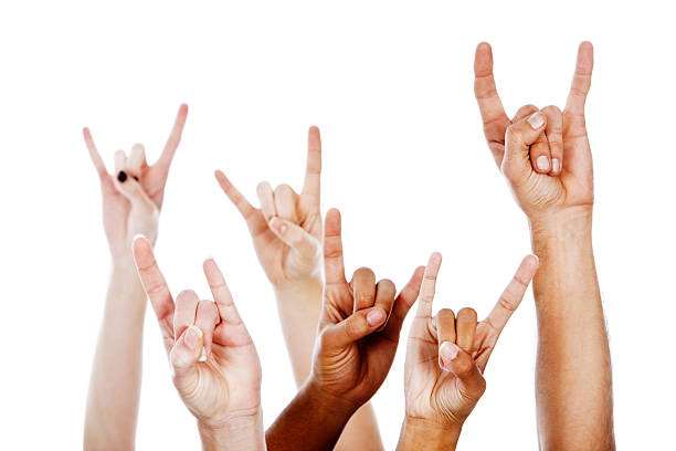 Rock on! Multiracial devil horns hand sign Hands of rockers of different ethnicities and sexes giving the heavy metal "devil horns" sign. horn sign stock pictures, royalty-free photos & images