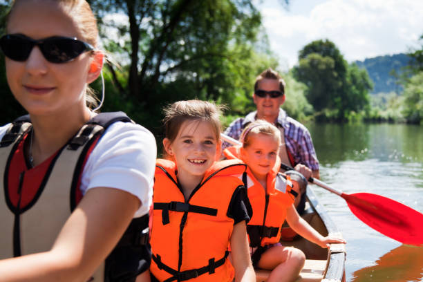 young family in a canoe on the neckar river in germany. 
