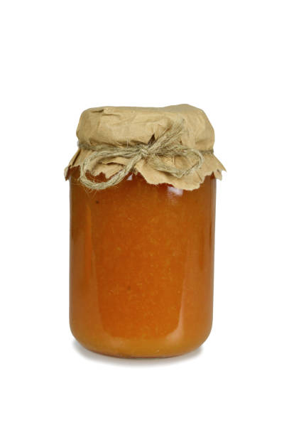 Apricot jam jar isolated on white background