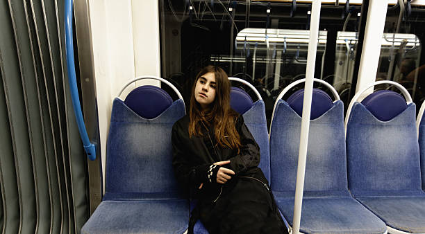 Girl in subway Young girl commuting on subway. 400 ISO. train interior stock pictures, royalty-free photos & images