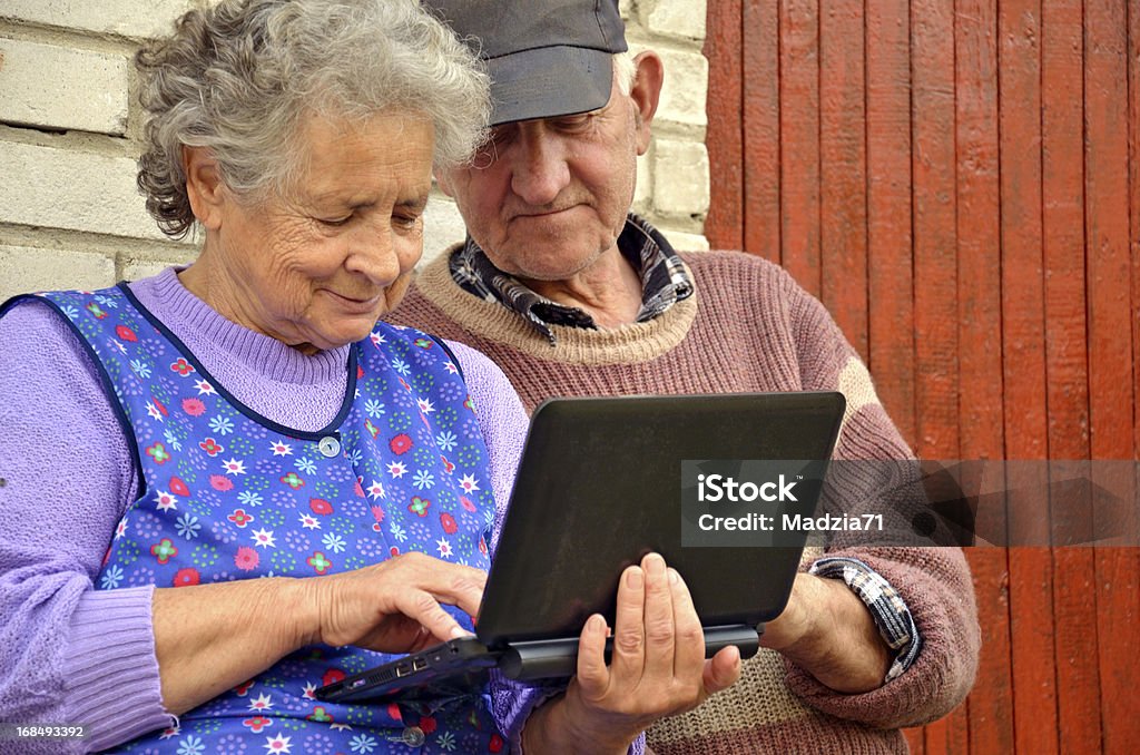 Senior couple with a netbook Senior farmers couple with a netbook. Active Seniors Stock Photo