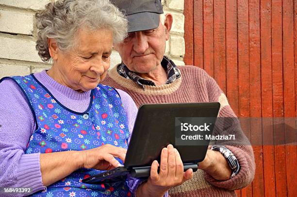 Senior Couple With A Netbook Stock Photo - Download Image Now - Active Seniors, Adult, Adults Only