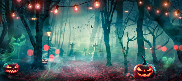 istock Halloween - Hunted Forest With Pumpkins And Ghosts At Moonlight - Jack O’ Lanterns In Cemetery With String Light At Twilight 1684944137