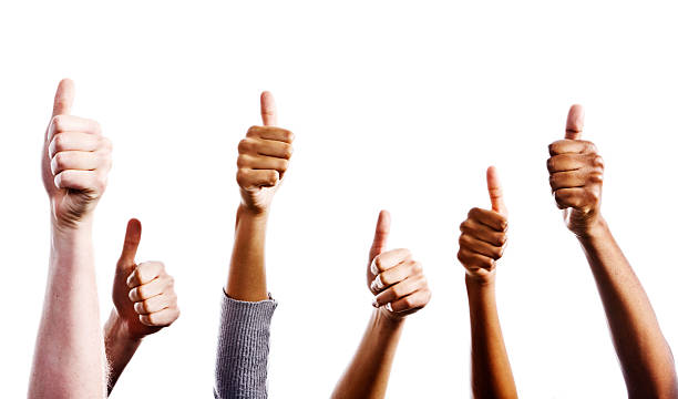istock Many mixed hands giving approving thumbs-up sign against white 168495015