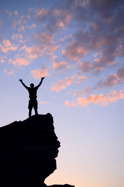 istock silhouette sunset arms spread wide 168495738
