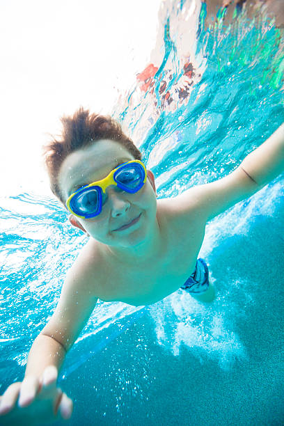 istock Young boy wearing goggles underwater 168497062