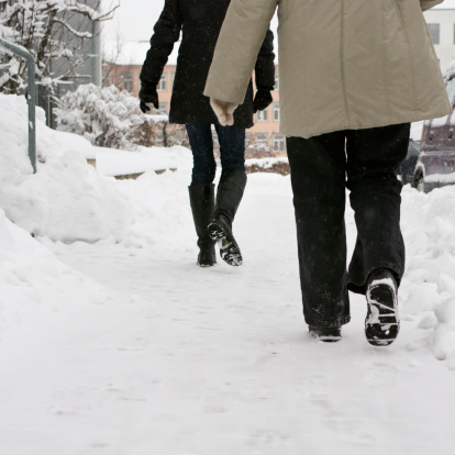 Two women walking on a snowcovered sidewalk.http://tools.stock-board.info/lightboxes/image-aa8e5a86f6cf5dfc371d187ce7adca8e.png