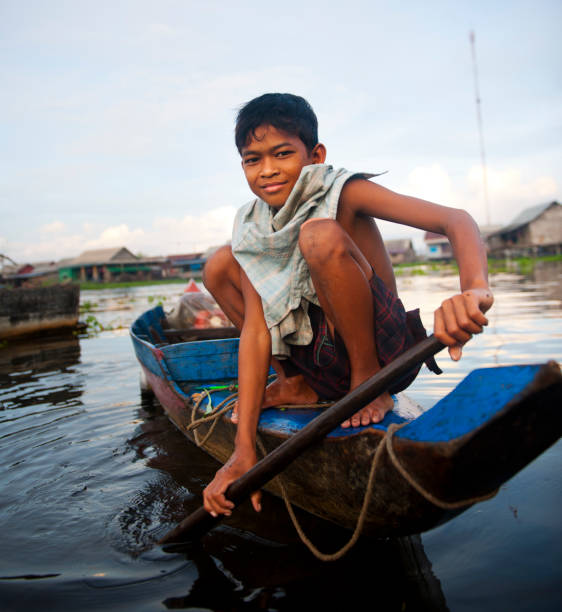 istock Cambodian boy travelling by boat 168497743