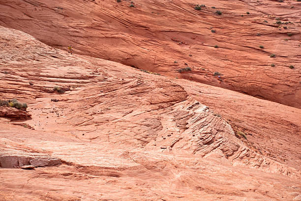 istock huge sandstone landscape and man 168497842