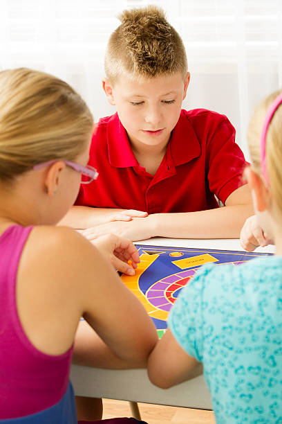 istock Group of kids playing a board game 168498526