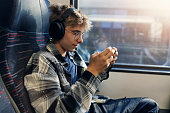 Teenage boy travelling by modern train