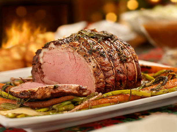 Christmas Roast Beef Dinner Prime Rib Roast Beef Dinner, With Yorkshire Pudding,Roasted Carrots, Asparagus and Fresh Herbs  -Photographed on Hasselblad H3D2-39mb Camera roast beef photos stock pictures, royalty-free photos & images