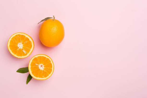 istock Flat lay with fresh oranges and leaves on color background 1685034001