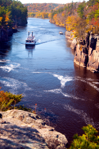 A paddle boat cruises down the St. Croix River in Wisconsin and Minnesota on a beautiful Autumn day.