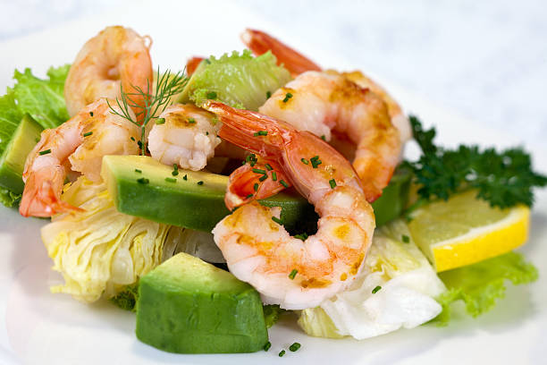 Shrimp Salad Shrimp salad with lettuce, avocado and cream sauce. seafood salad stock pictures, royalty-free photos & images