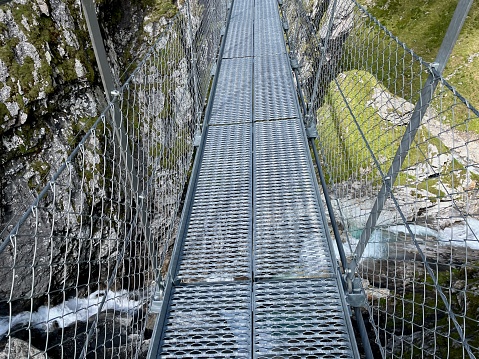 Aerial view of suspension bridge at Greina Ebene in Grisons, Switzerland.