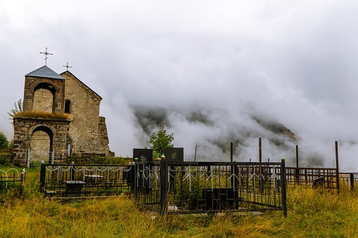 A beautiful, rural church situated on a hill in a foggy landscape
